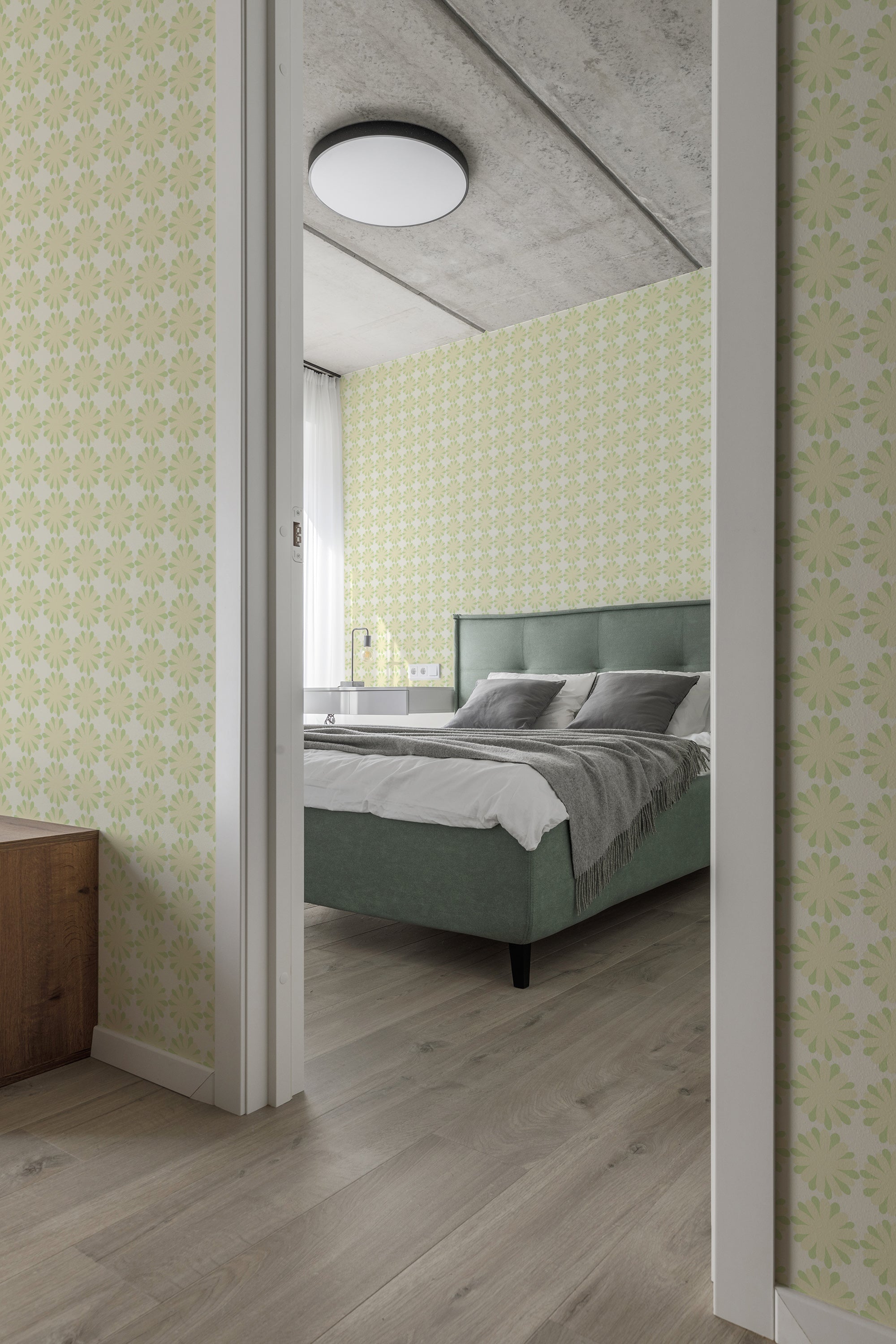 A bedroom wall adorned with light green wallpaper covered in a repeating pattern of small flower-like circles, creating a soft and elegant look. The traditional wallpaper adds a touch of classic charm to the modern interior.