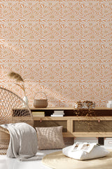 A room with wallpaper covered in a vibrant sunflowers pattern with geometric shapes in shades of warm orange, white, and tan. The design creates an eclectic and lively atmosphere. The wallpaper extends from the floor to the ceiling, complementing the minimalist and natural decor of the room. Traditional wallpaper.