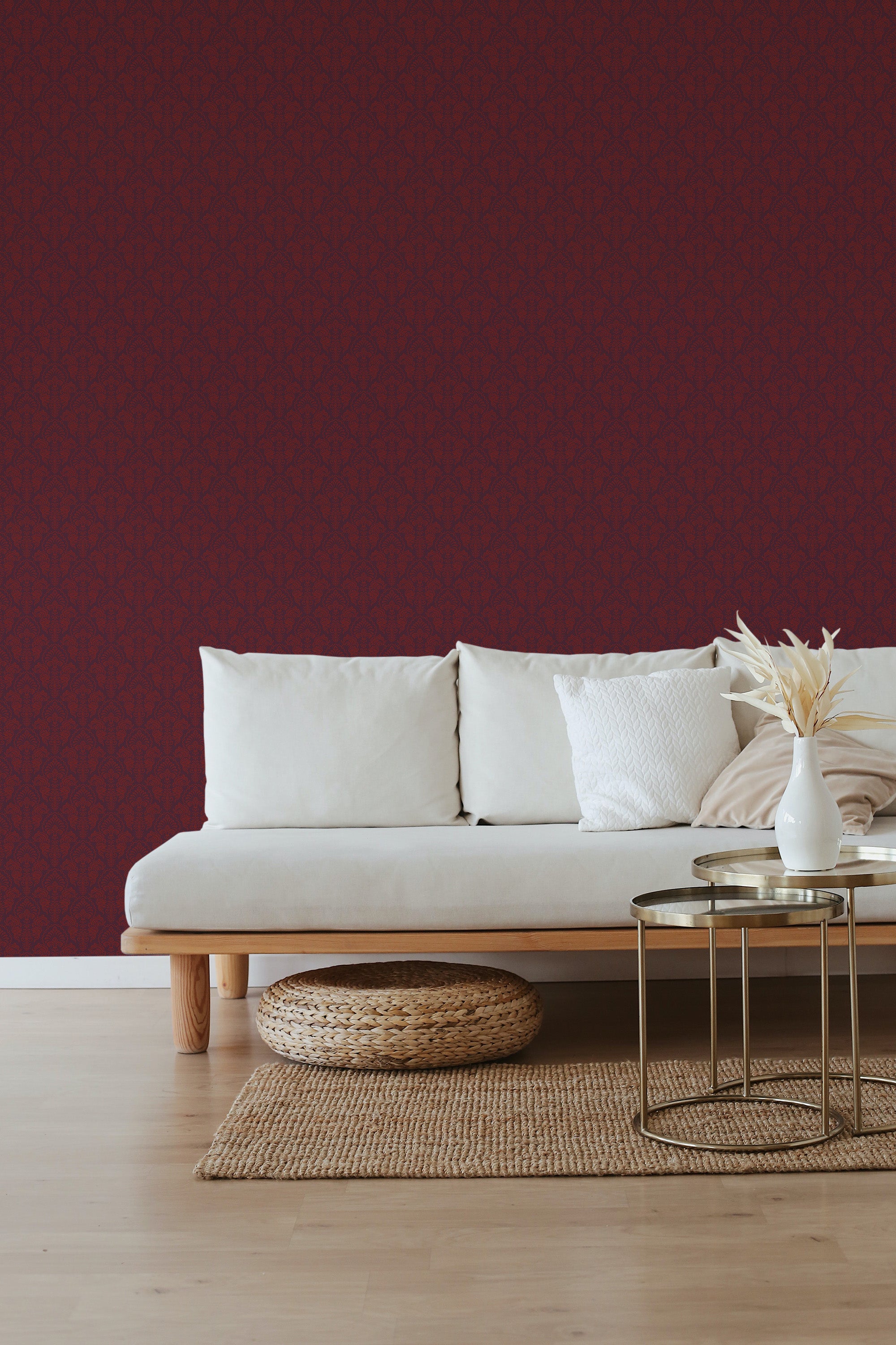 A room with a textured Burgundy damask wallpaper pattern on one wall, complemented by a modern sofa and minimalist decor, illustrating a blend of traditional wallpaper and contemporary style.