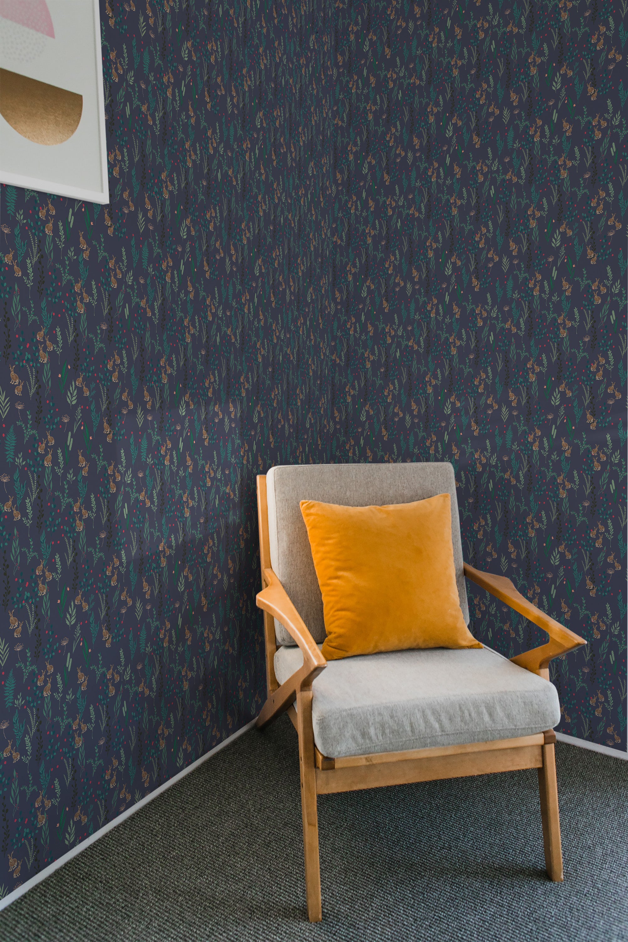 A room with Dark blue forest wallpaper, showing trees and leaves in a repeating pattern, complementing a modern armchair with a yellow cushion, evoking a natural ambience with a touch of traditional wallpaper.