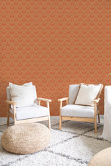 A room with orange wallpaper with a swan pattern, complemented by wooden furniture and a cozy, white cushioned seating area, traditional wallpaper.