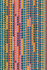 A pattern of multicolored zigzag stripes with a retro vintage geometric style on a peel and stick removable wallpaper.