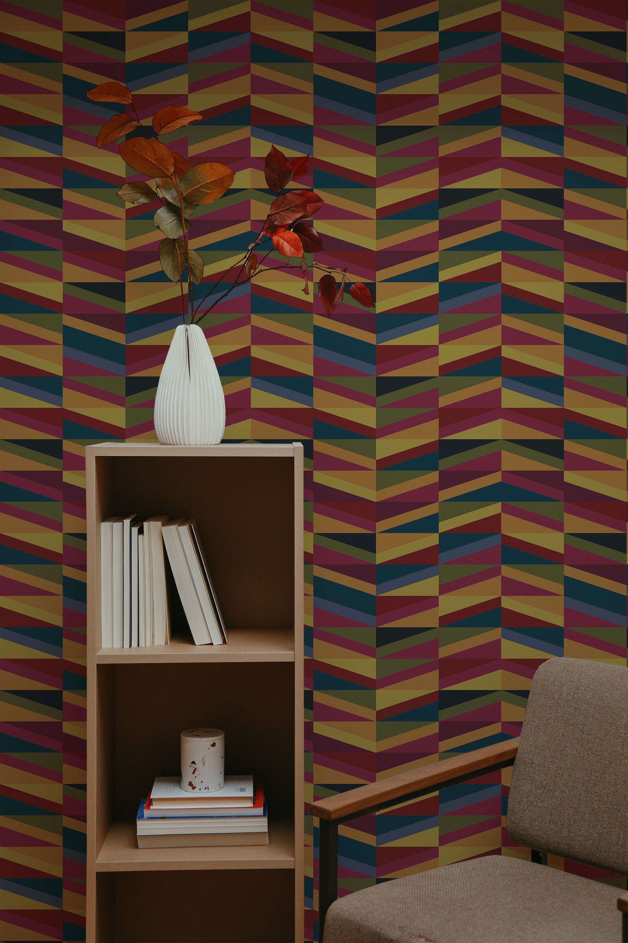 Self-adhesive wallpaper with a geometric pattern of colorful bold triangles in shades of purple, pink, brown, and beige, creating a vibrant accent wall in a room with modern decor.
