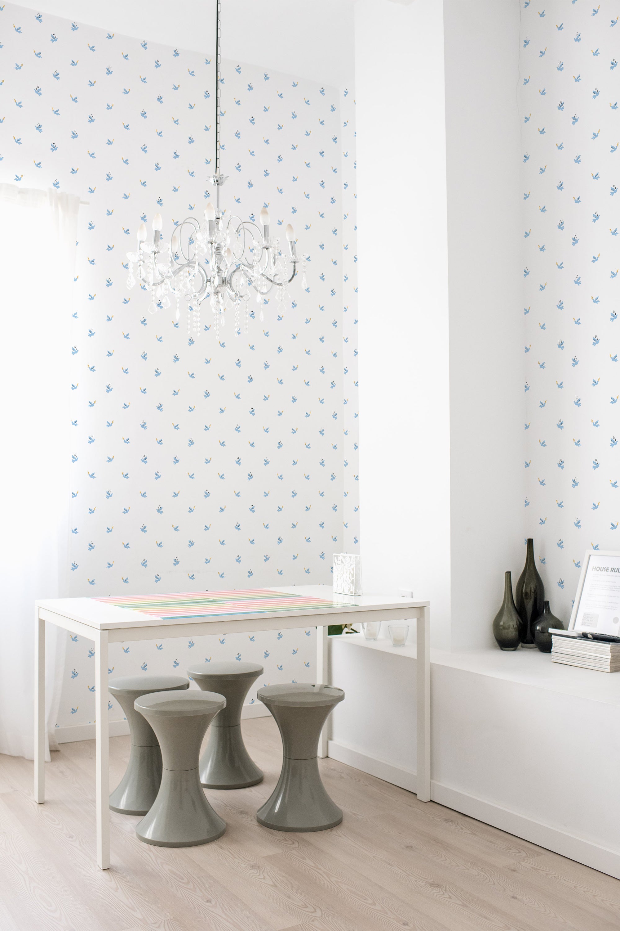 Light blue wallpaper with a repeated pattern of small, stylized white peace doves accentuated by dotted lines, in a bright interior setting, evoking a serene and classic ambiance, traditional wallpaper.