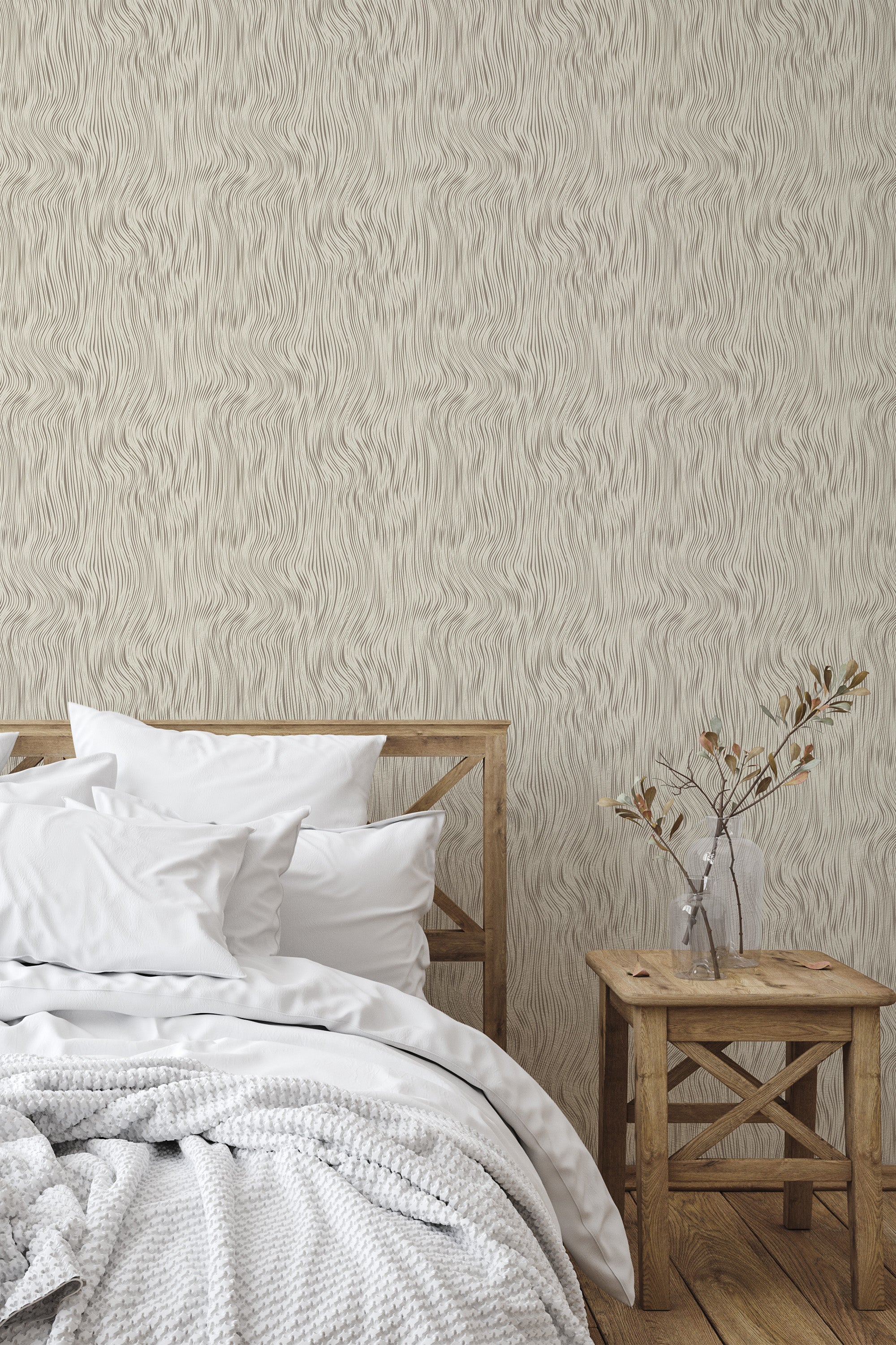 Self-adhesive wallpaper with a monochromatic wave pattern in a seamless optical design on a bedroom wall, complementing a simple wooden bed and stool.