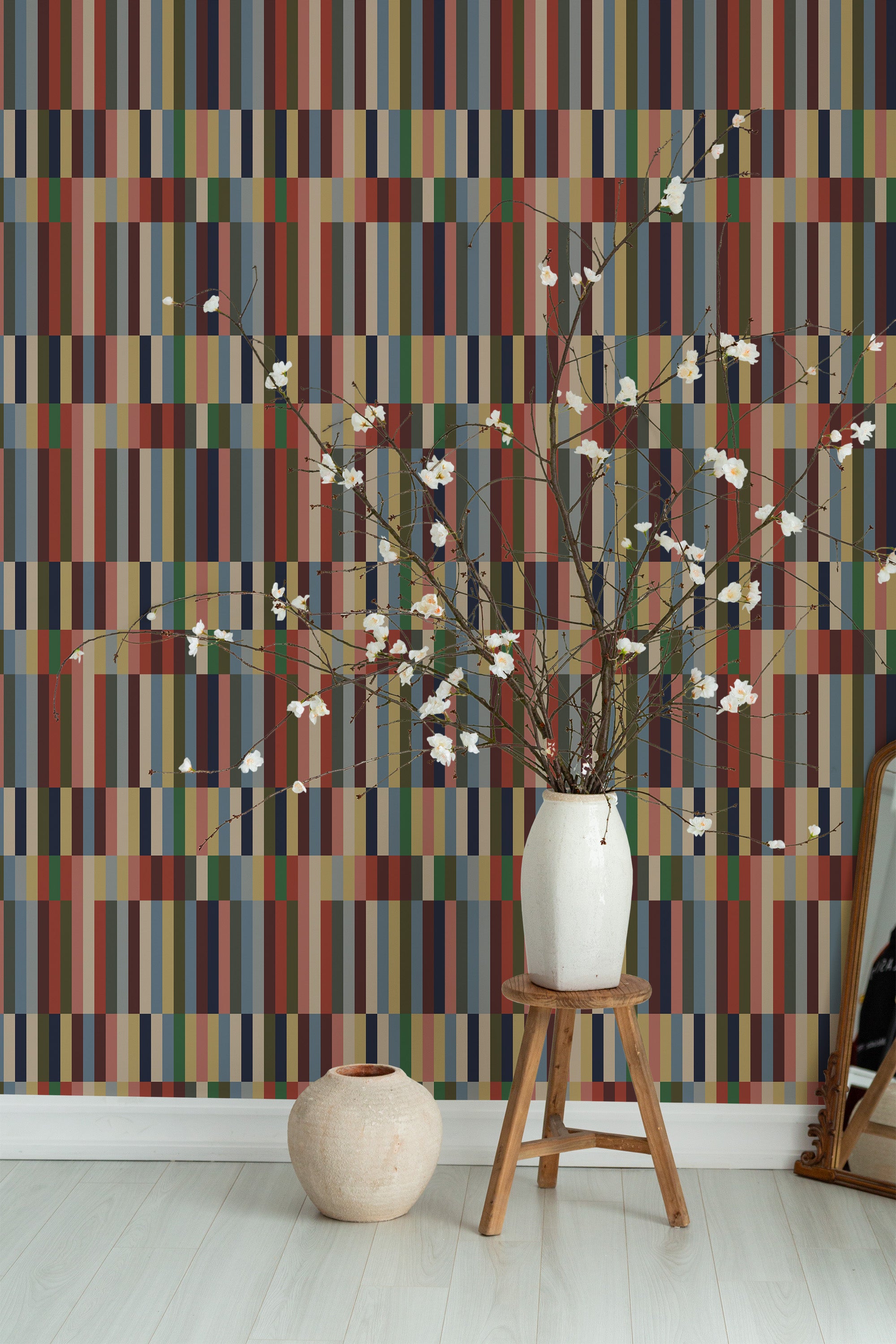 Self-adhesive Earthy striped wallpaper with vertical lines in varying shades of brown, blue, and beige, giving a natural and warm feeling to the room.