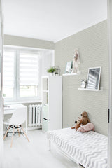 A light room with white furniture, berry patterned wallpaper with small, delicate berry and leaf motifs in a repeating design, lending a subtle yet traditional wallpaper feel.