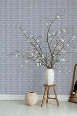 Self-adhesive Purple Love Bird wallpaper with a pattern of stylized birds and hearts in shades of purple on a light background, accompanied by a vase on a stool.
