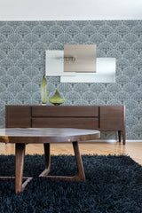 A room with Art Deco-style tree patterned wallpaper in monochrome, complementing the modern wooden furniture and dark blue rug, traditional wallpaper.