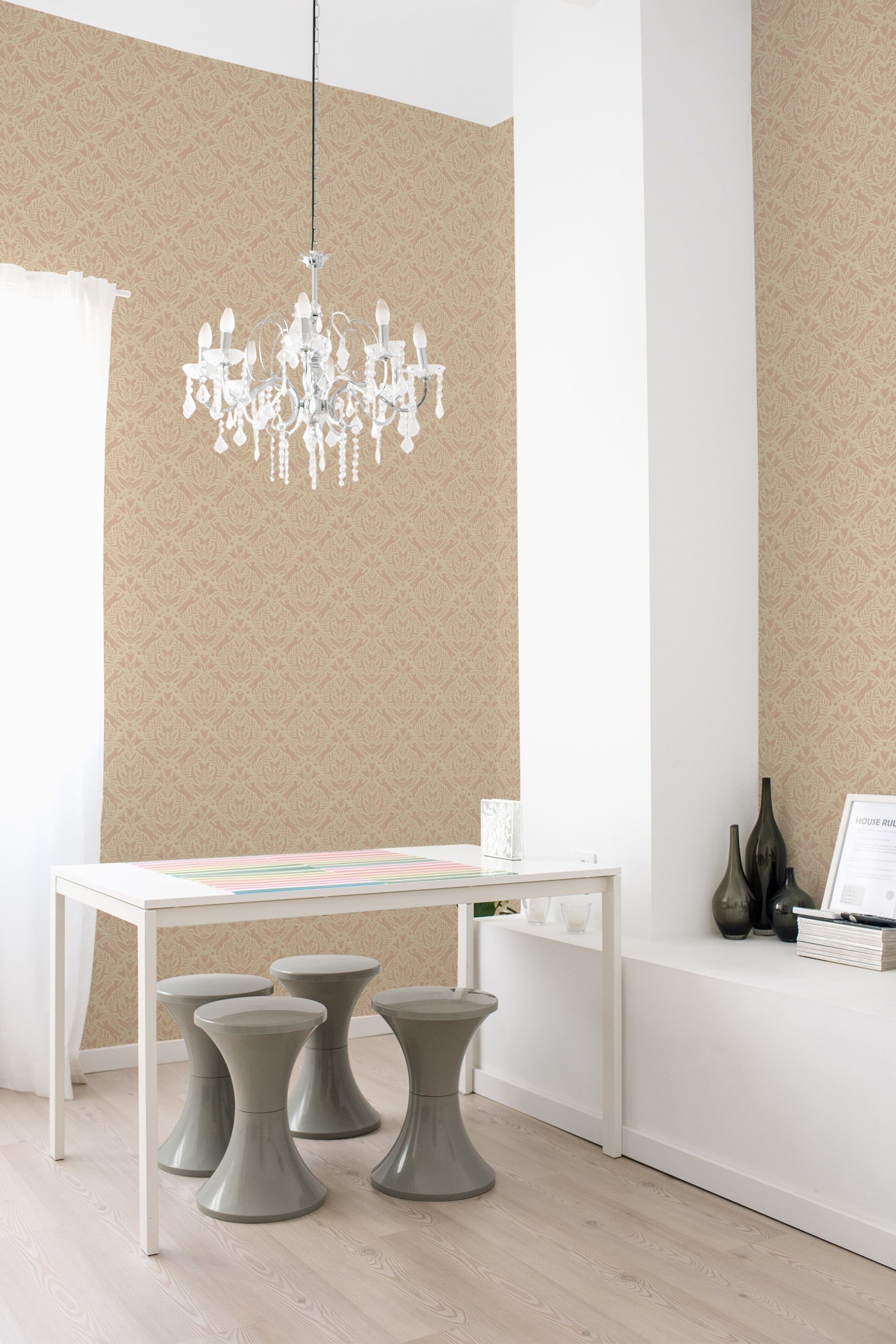A room with Woodland design wallpaper on one wall, including stylized trees and foliage in a repeating pattern, complemented by a white chandelier, furniture, and decor, embodying a traditional wallpaper style.