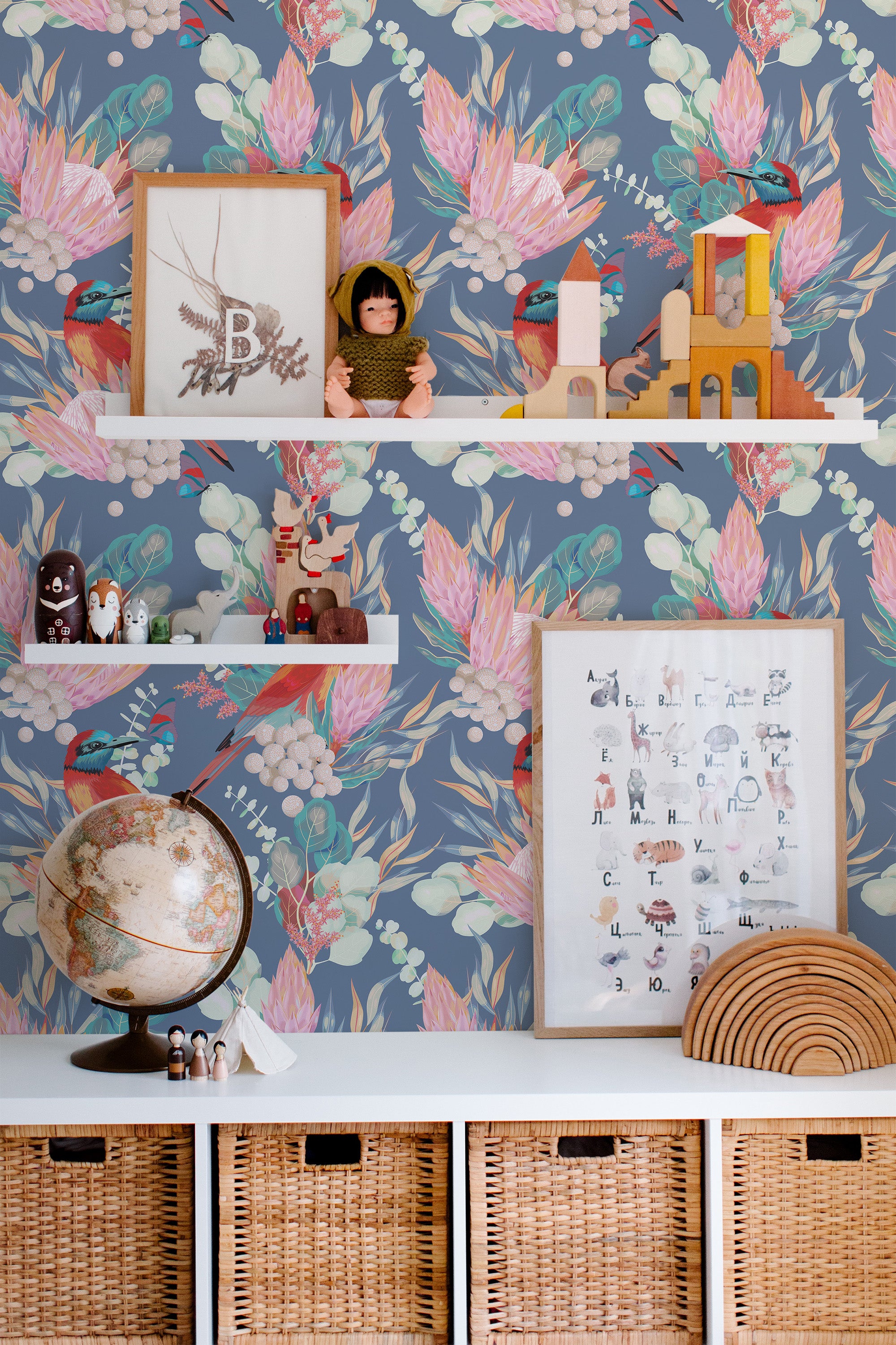 Self-adhesive wallpaper with a Tropical Bird design, including vibrant pink birds amidst green foliage on a blue background, in a child's room with educational toys and decor.