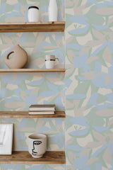 Self-adhesive wallpaper with a soft floral pattern in pastel blue and green hues on a beige background, providing a relaxed and modern aesthetic to the room.