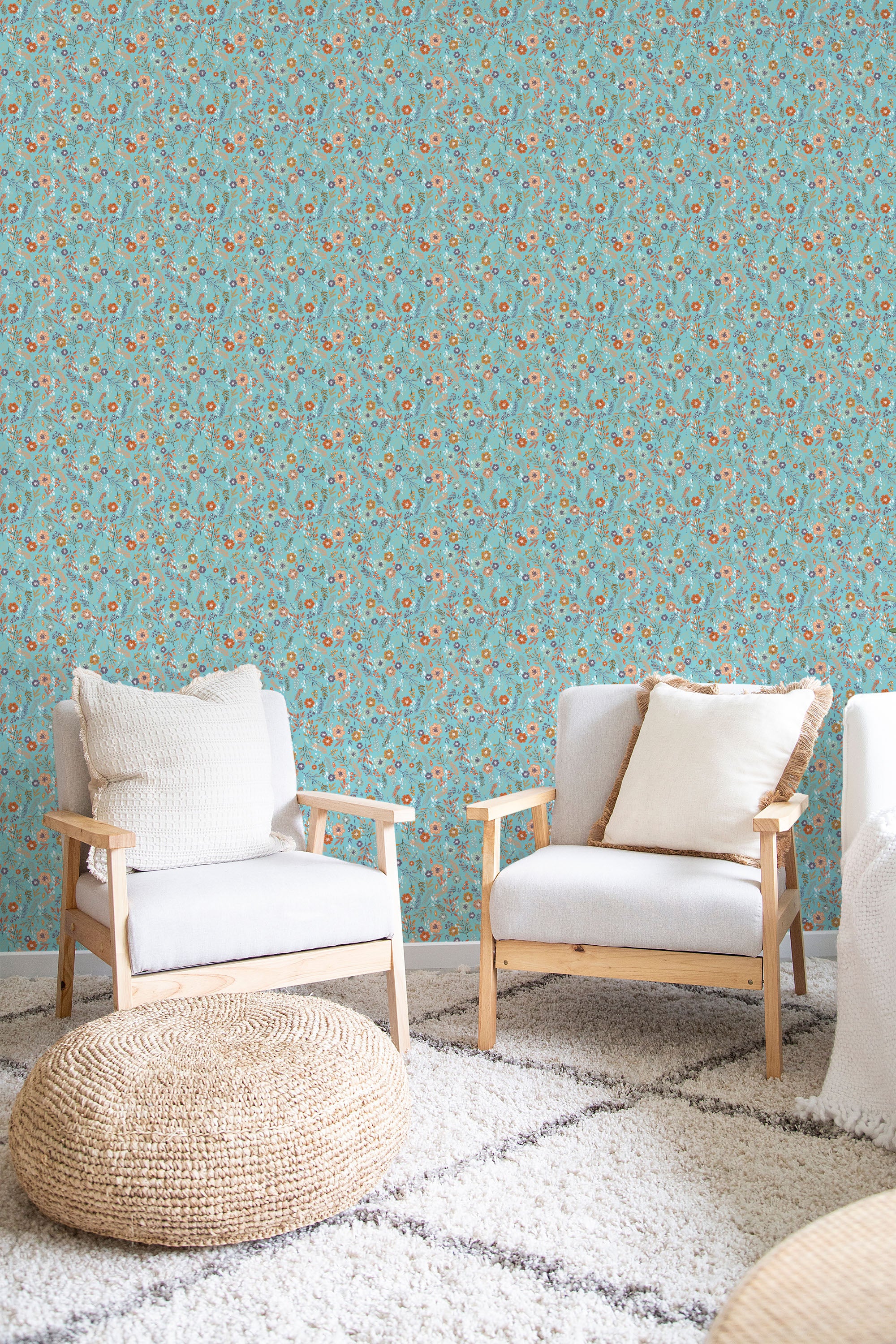 Light blue wallpaper with small red and yellow floral patterns in a room with wooden armchairs and a woven ottoman on a white rug, traditional wallpaper.