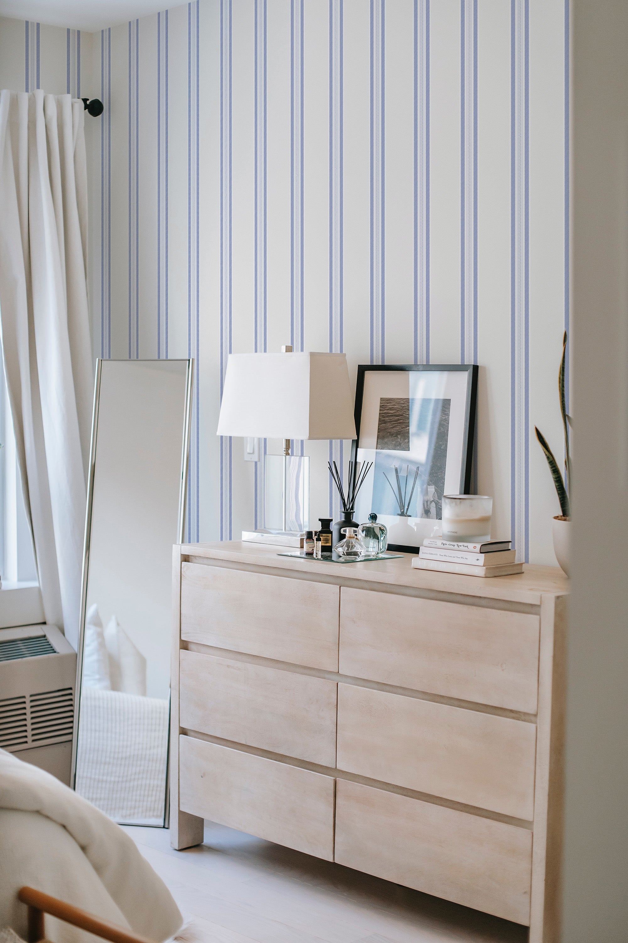 peel and stick wallpaper classic blue french stripes accent wall bedroom dresser mirror minimalist interior