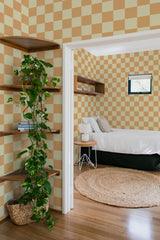 bedroom cozy interior green plants round carpet checkered yellow and orange peel & stick wallpaper