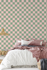 simple cozy bedroom pillows blankets checkered pink and green wall decor