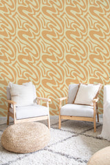 cozy living room soft armchairs pillows funky orange and yellow wall decor