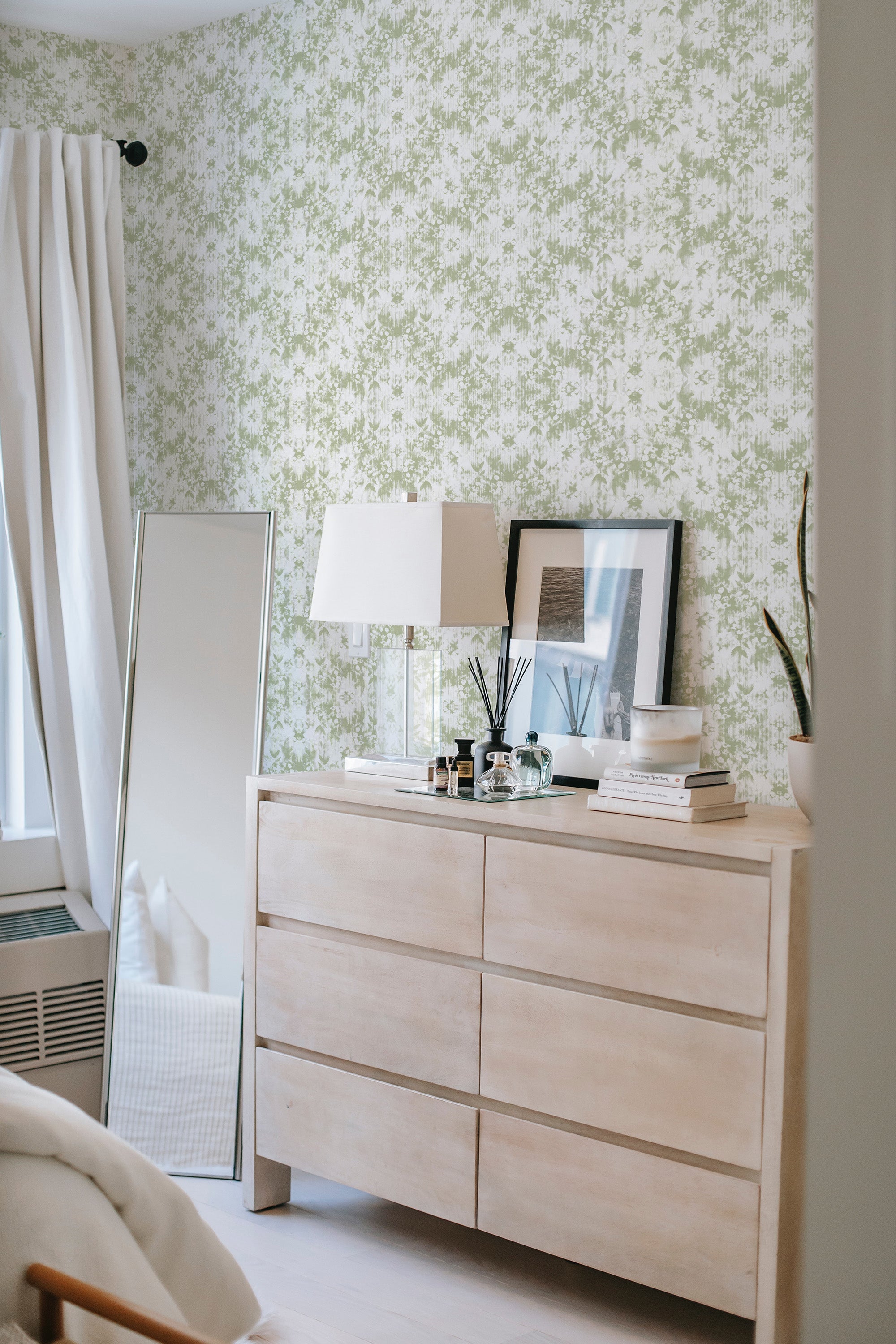 peel and stick wallpaper subtle green florals accent wall bedroom dresser mirror minimalist interior
