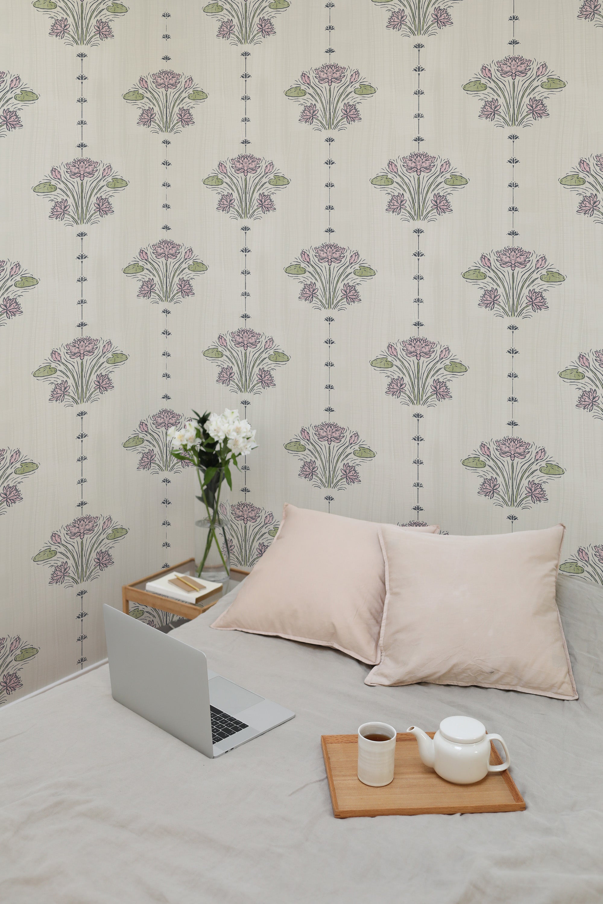 Delicate Lotus Sprigs peel and stick wallpaper on a bedroom wall, spaced pink lotus bouquets with vertical dotted stripes.