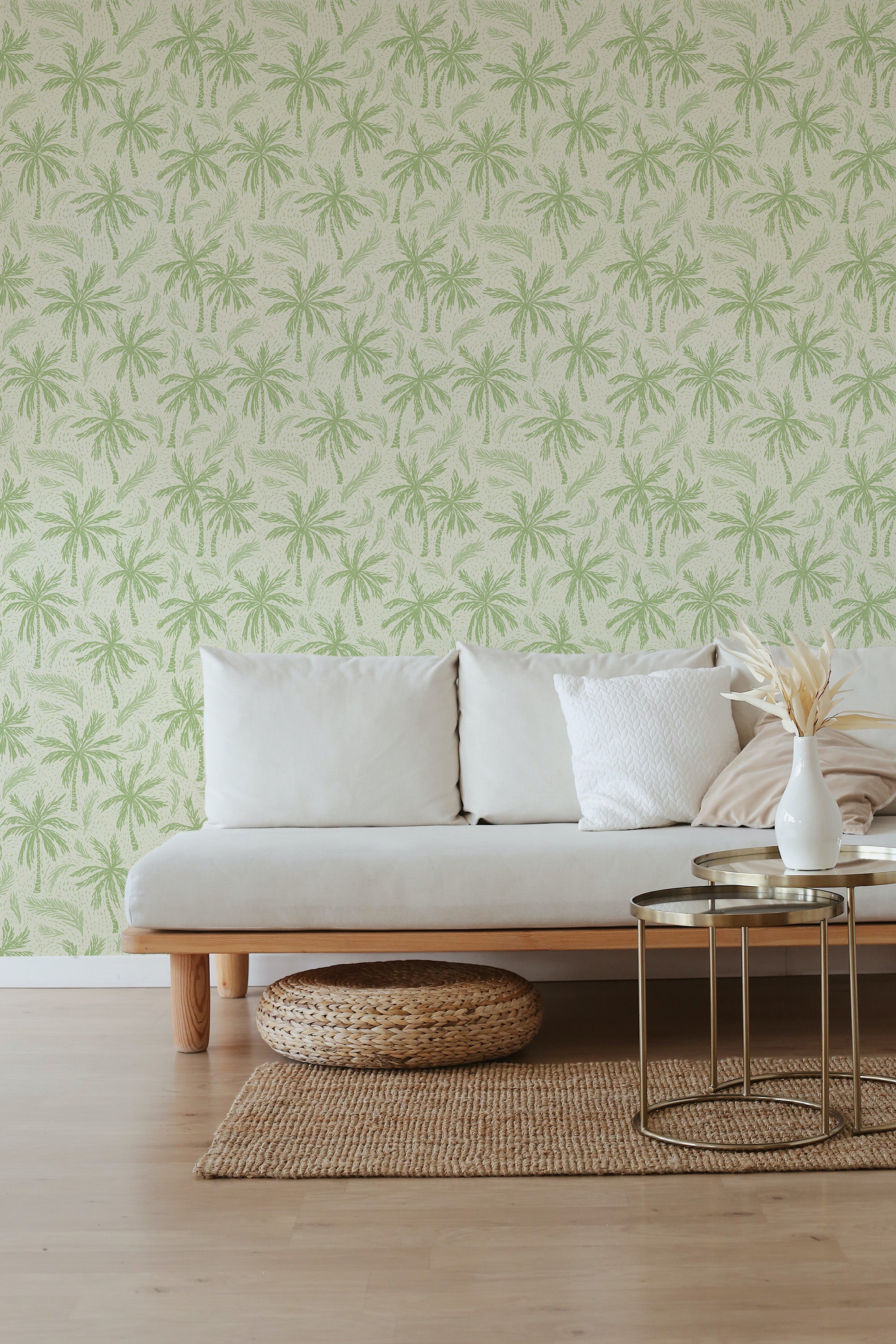 Breezy Palm Grove peel-and-stick wallpaper in a living room, shown as a full wall with a pale green palm tree repeat on a light beige background.