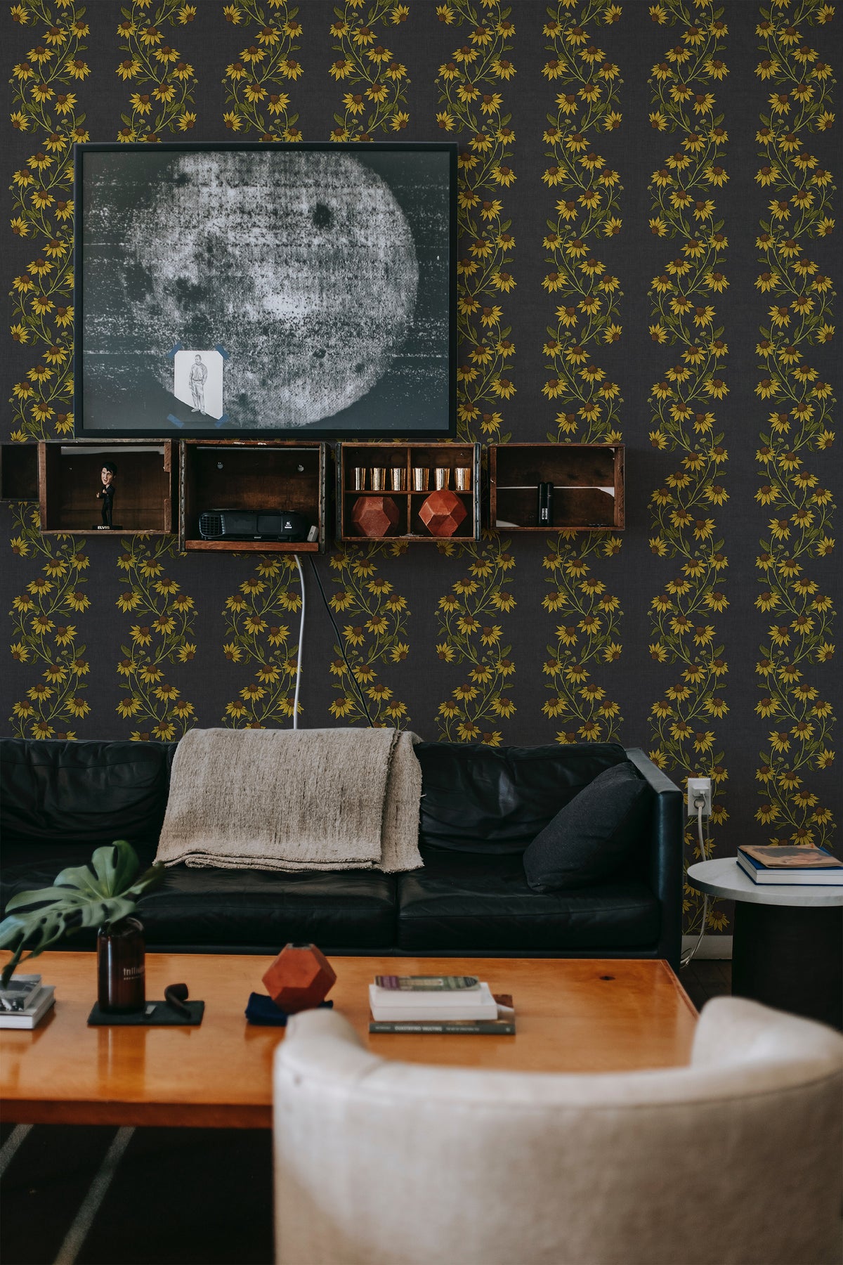 Trailing Sunflowers peel and stick wallpaper on a living room accent wall with trailing yellow sunflowers on charcoal gray.