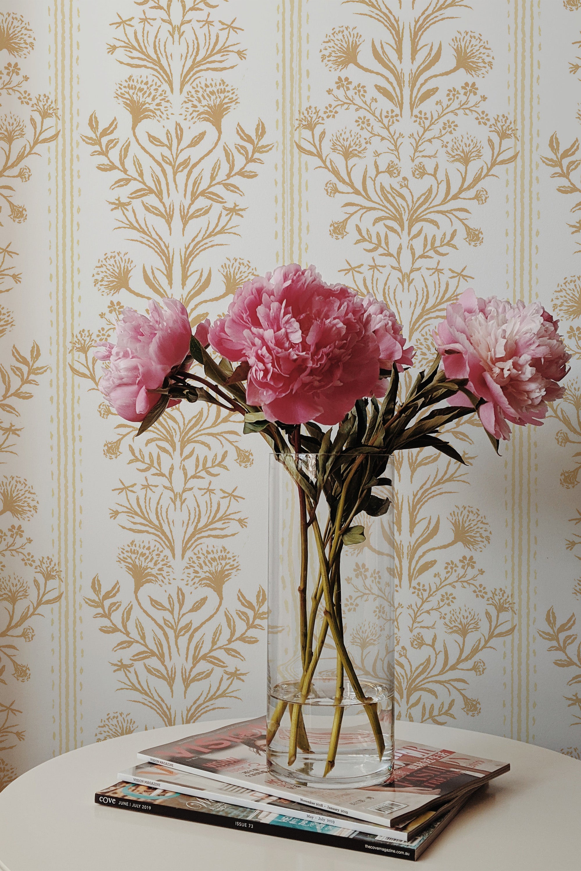 Ornate Damask peel and stick wallpaper on an interior wall with tan damask motifs and narrow stripes on off-white.