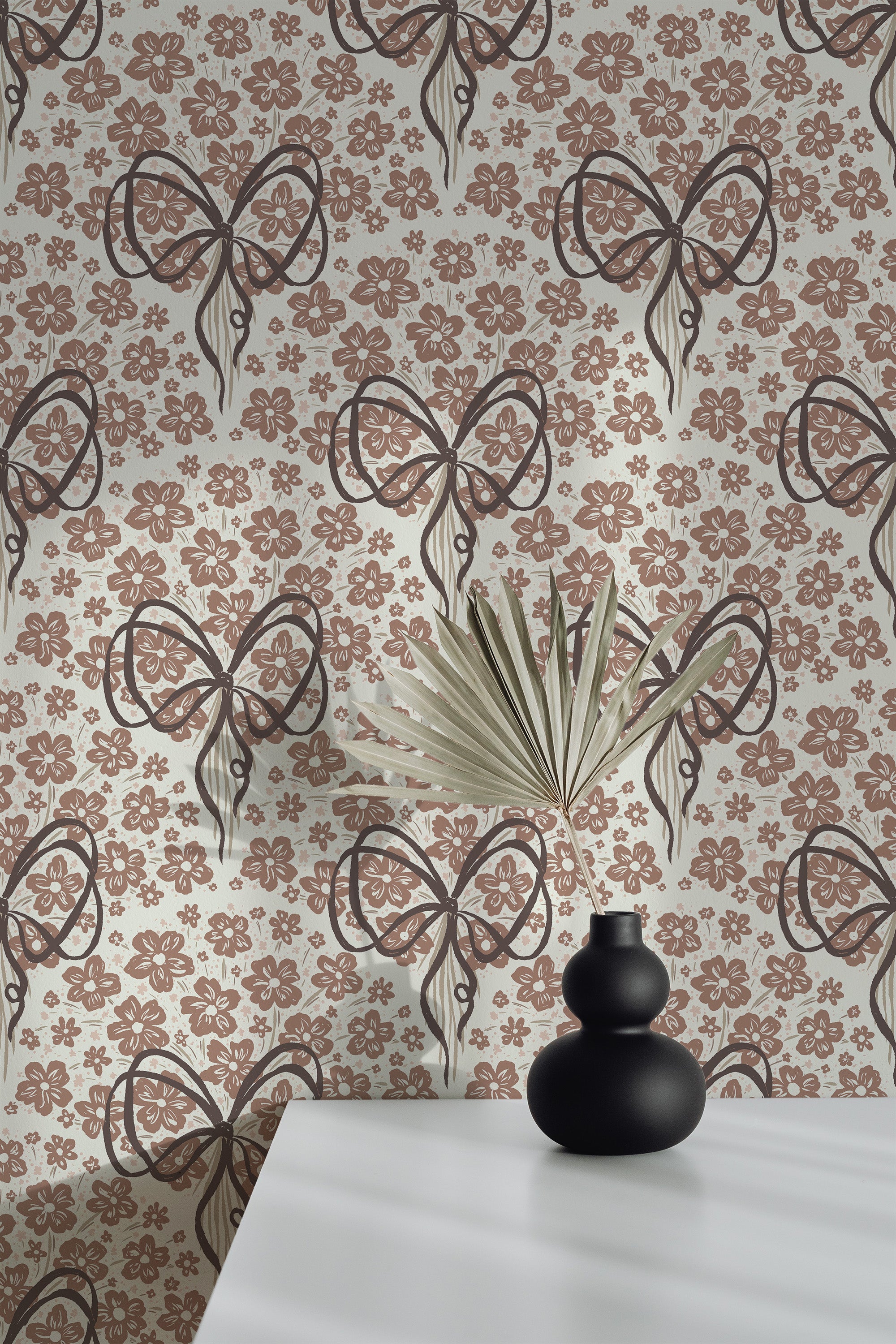 Playful Floral Bows self-adhesive wallpaper on an interior wall, with brown bows and small floral motifs on a warm beige ground.