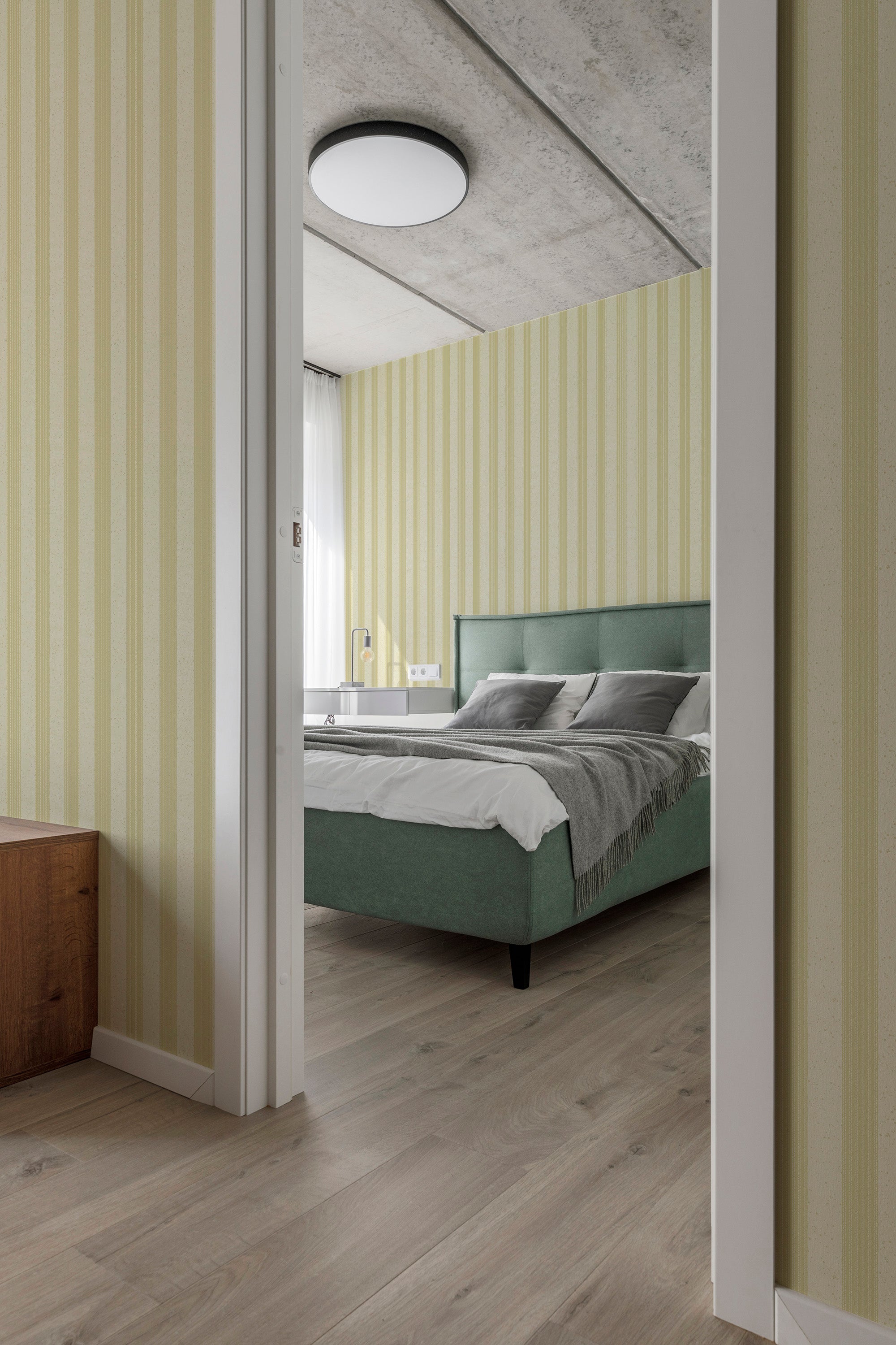 Speckled Stitch Stripe pre-pasted wallpaper in a bedroom, pale yellow vertical stripes with subtle speckled stitch detail.