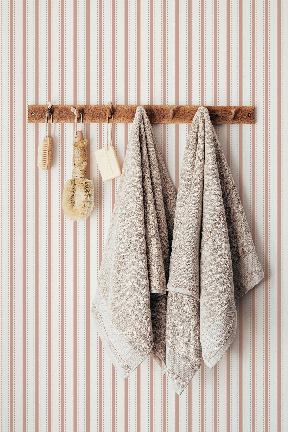 Delicate Pinstripe self-adhesive wallpaper on a full bathroom wall, with orange dotted stripes on white.