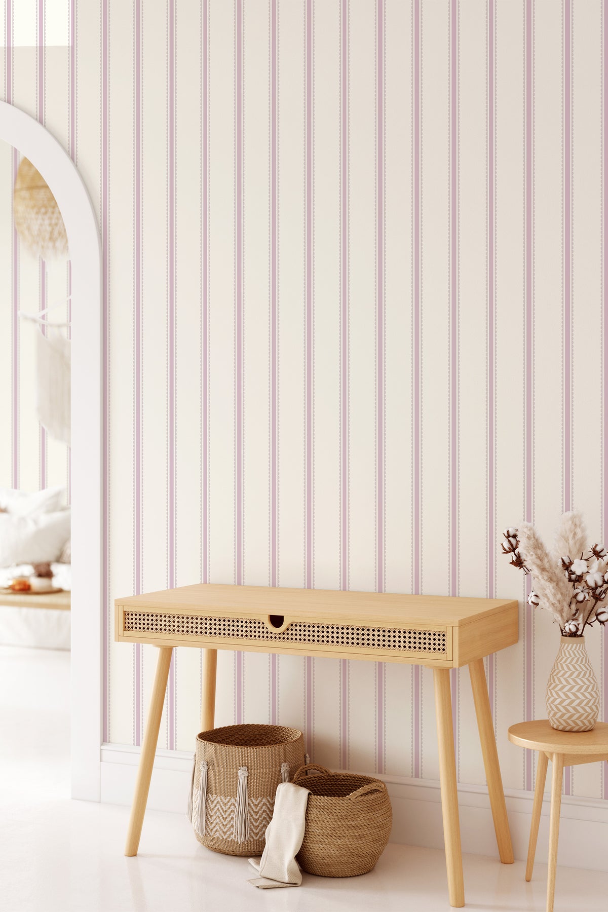 Pastel Scallop Stripe grasscloth wallpaper on an interior wall, featuring a vertical blush scallop-stripe pattern.
