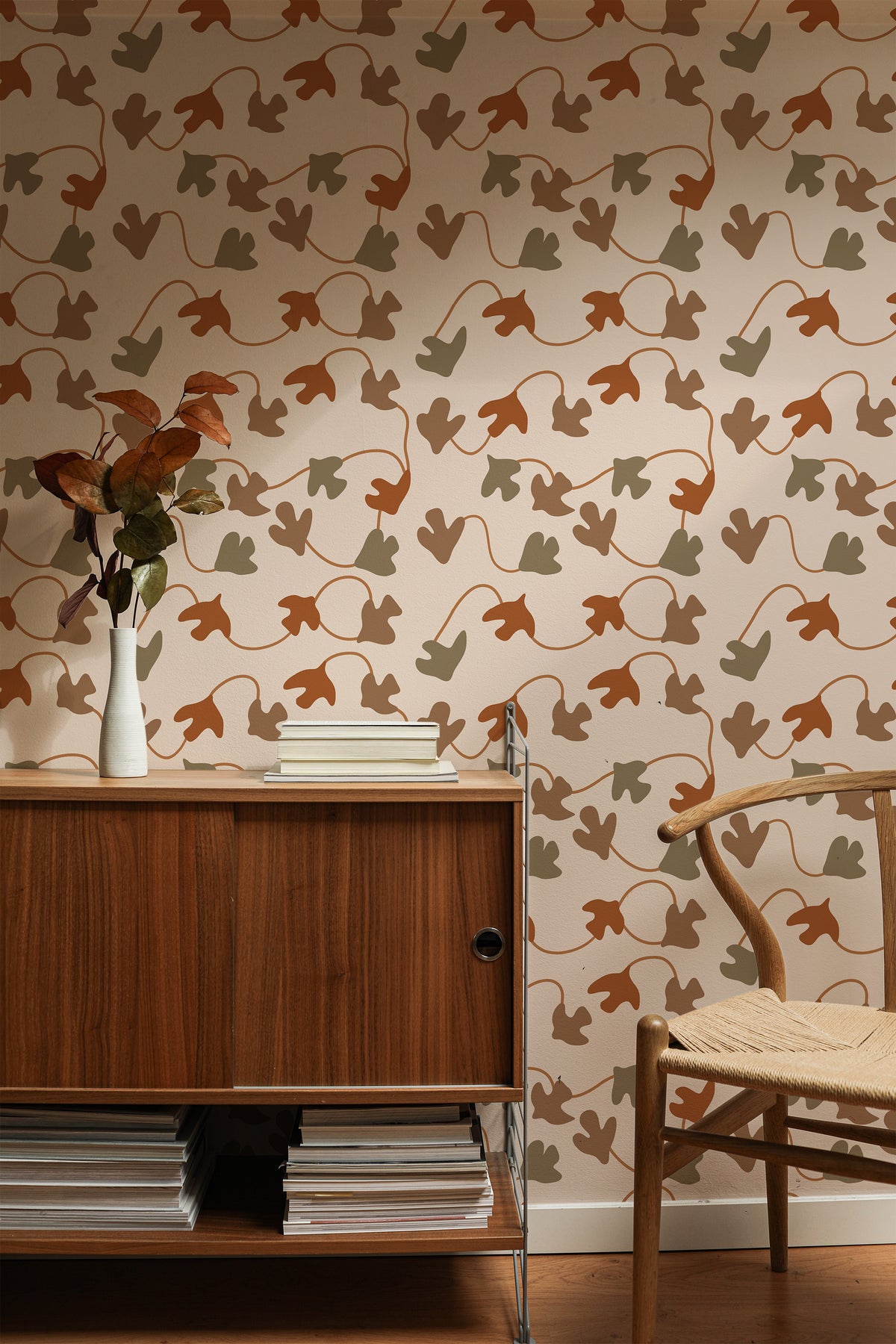 Organic Ivy Leaves peel-and-stick wallpaper on a styled interior wall with olive and rust ivy motifs on beige.