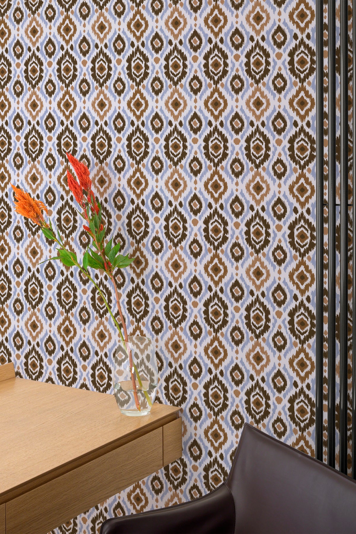 Bold Ikat Medallions grasscloth wallpaper on an interior wall with brown ikat medallions on pale blue.