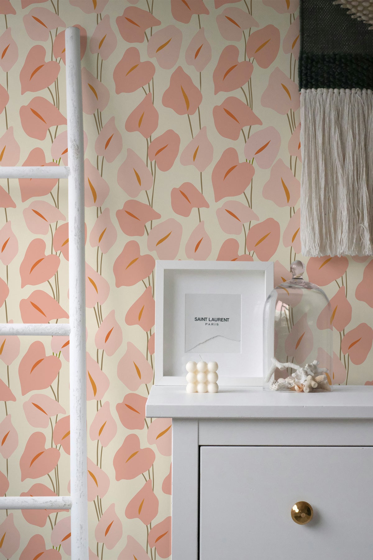 Playful Calla Lilies peel and stick wallpaper on an interior wall with pink calla lily motifs on beige.