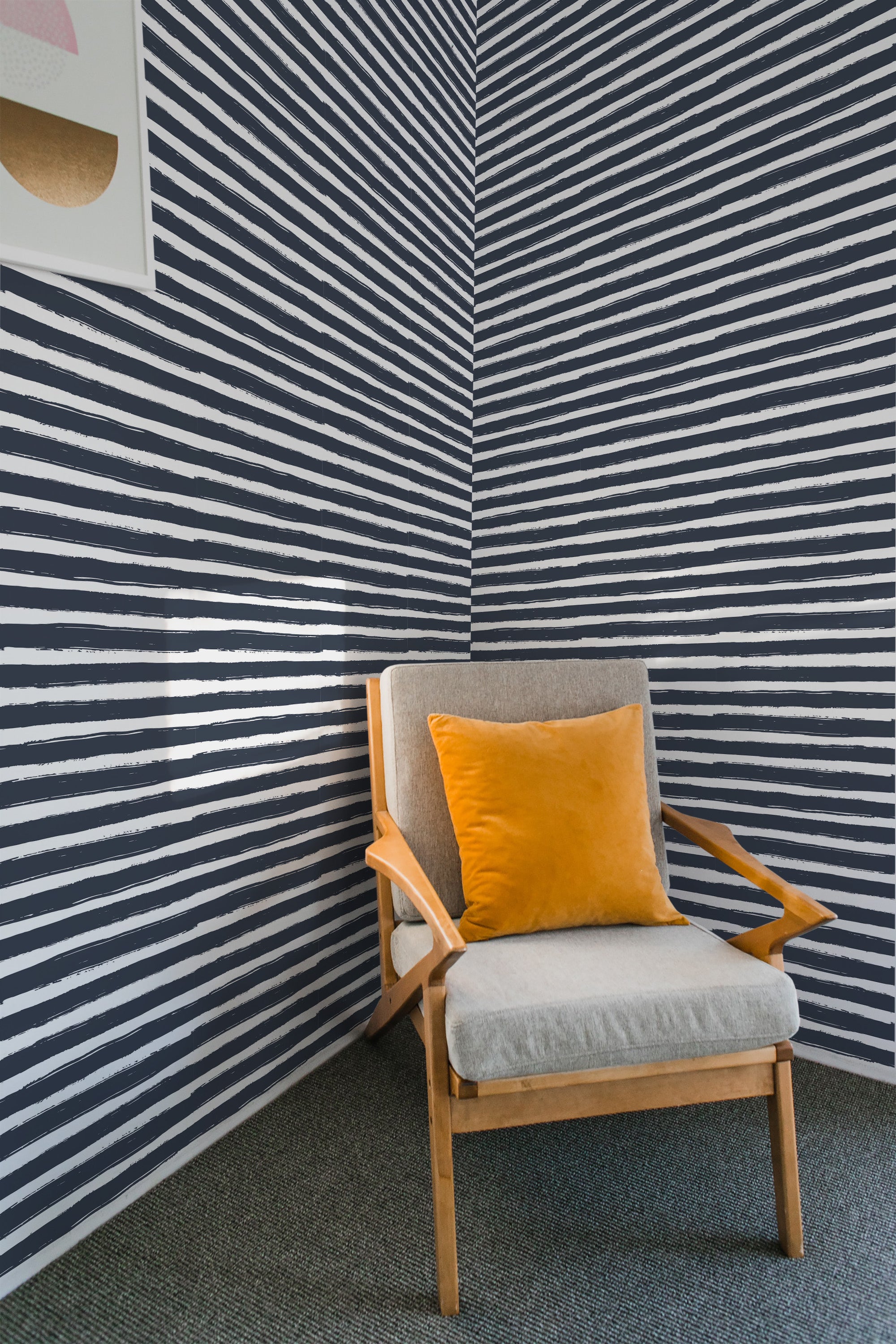 Navy and white horizontal brush stroke patterns on the wall create a textured, linear design, paired with a cozy armchair and yellow throw pillow in a corner, traditional wallpaper.