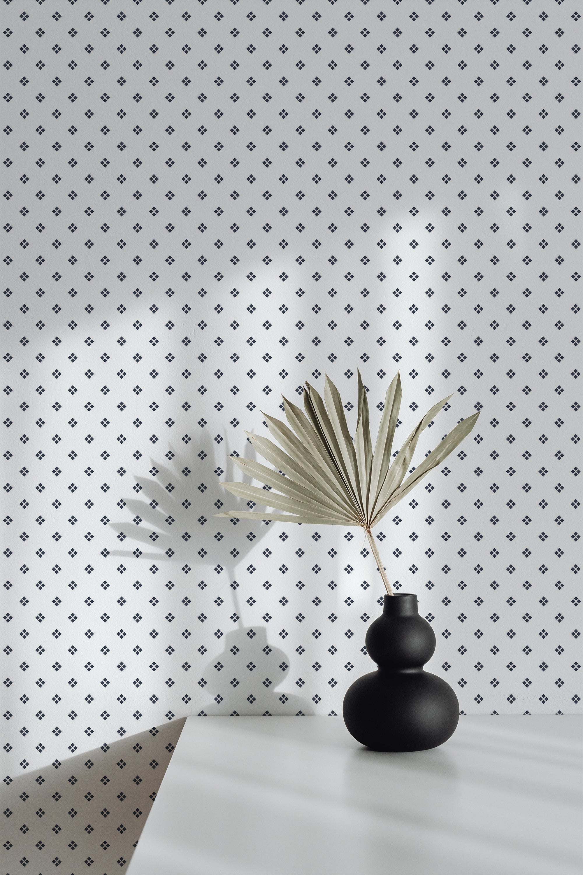 Self-adhesive wallpaper with a small rhomb pattern in black on a light grey background, providing an elegant geometric design.