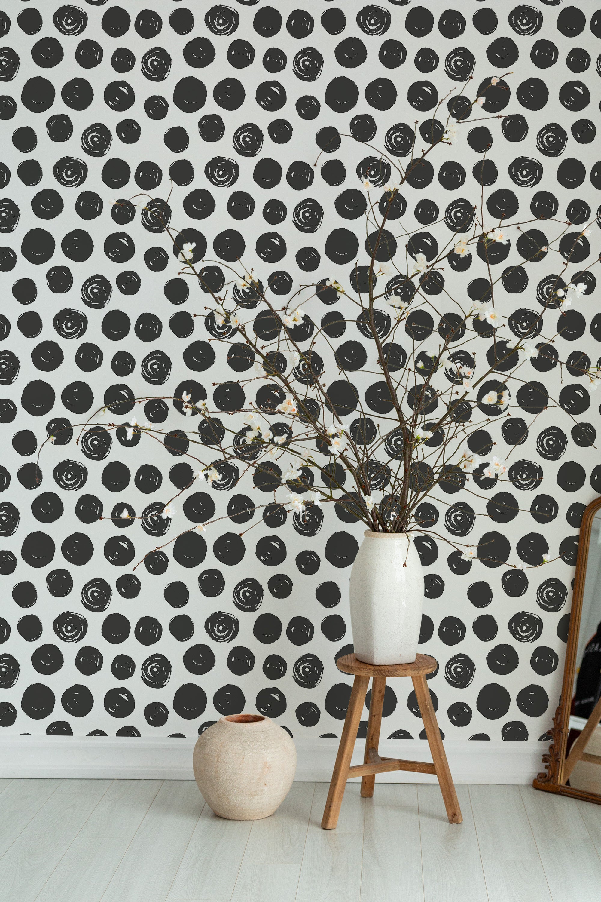 Self-adhesive wallpaper with a black brush stroke dots pattern on a white background, adding a modern and artistic touch to the room.
