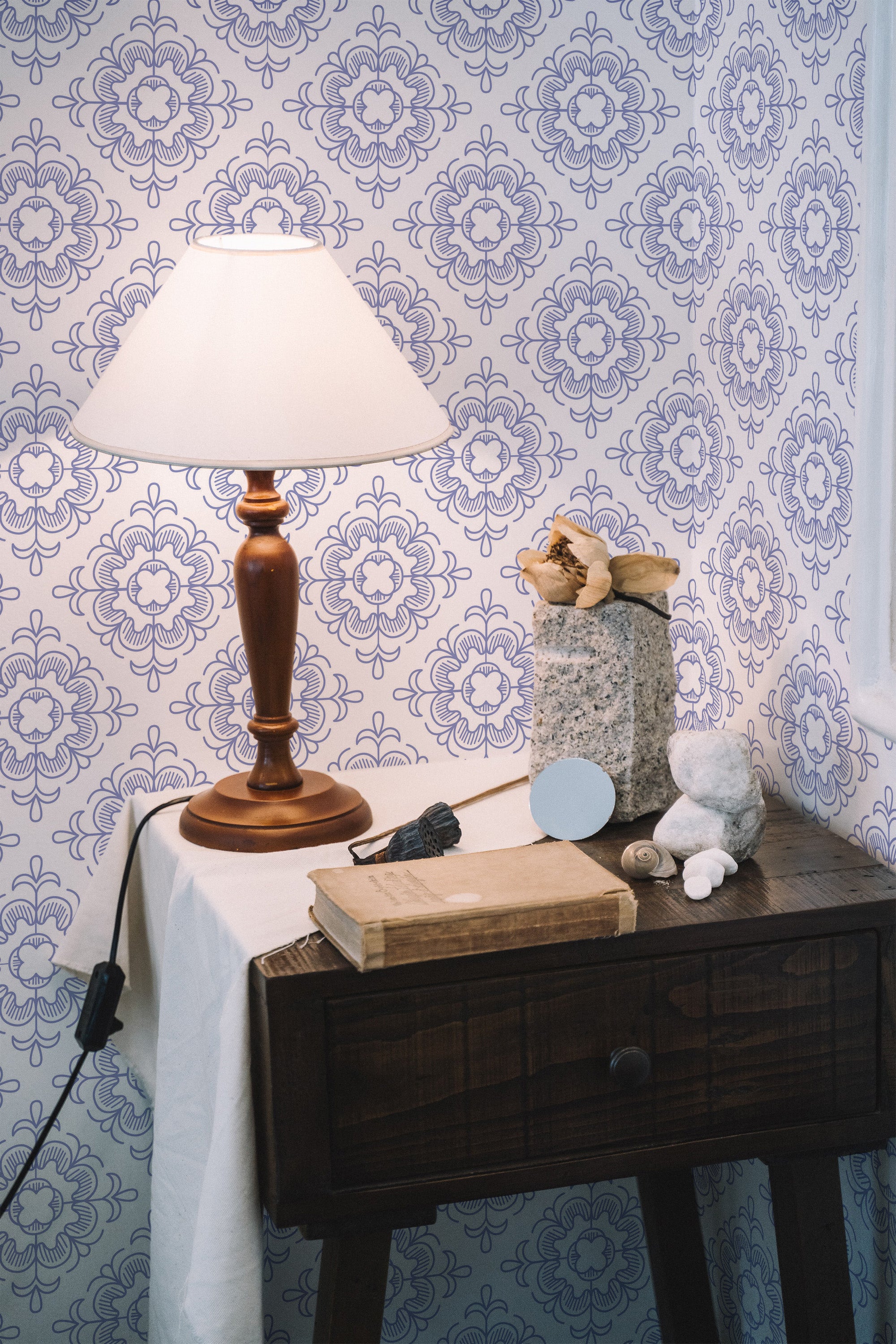 Self-adhesive wallpaper in a tile pattern with intricate blue floral motifs on a white background.