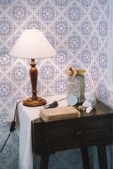 Self-adhesive wallpaper in a tile pattern with intricate blue floral motifs on a white background.