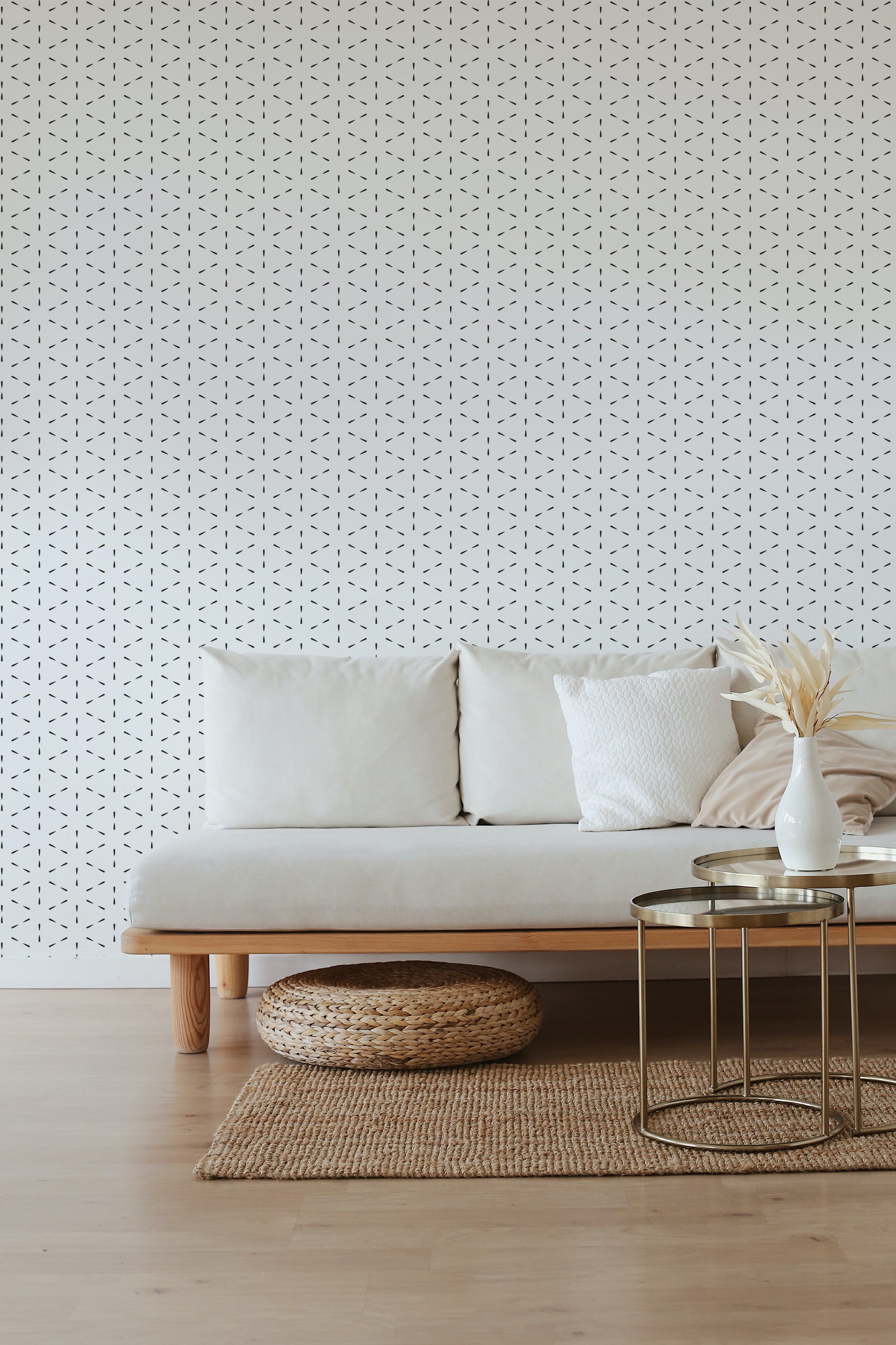 The wallpaper has a delicate, repeating pattern of small black lines arranged in a simple, geometric design on a white background, enhancing the room's understated elegance and minimalistic decor while retaining the charm of traditional wallpaper.