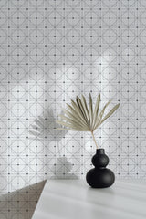 Self-adhesive wallpaper with delicate geometric design in light shades, featuring a grid of thin intersecting lines adorned with small dots at intersections, adding a modern and minimalist aesthetic to the room.