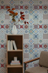 Self-adhesive wallpaper with a colorful tile design in various patterns, including floral and geometric shapes in shades of blue, red, yellow, and white, giving a vintage feel.