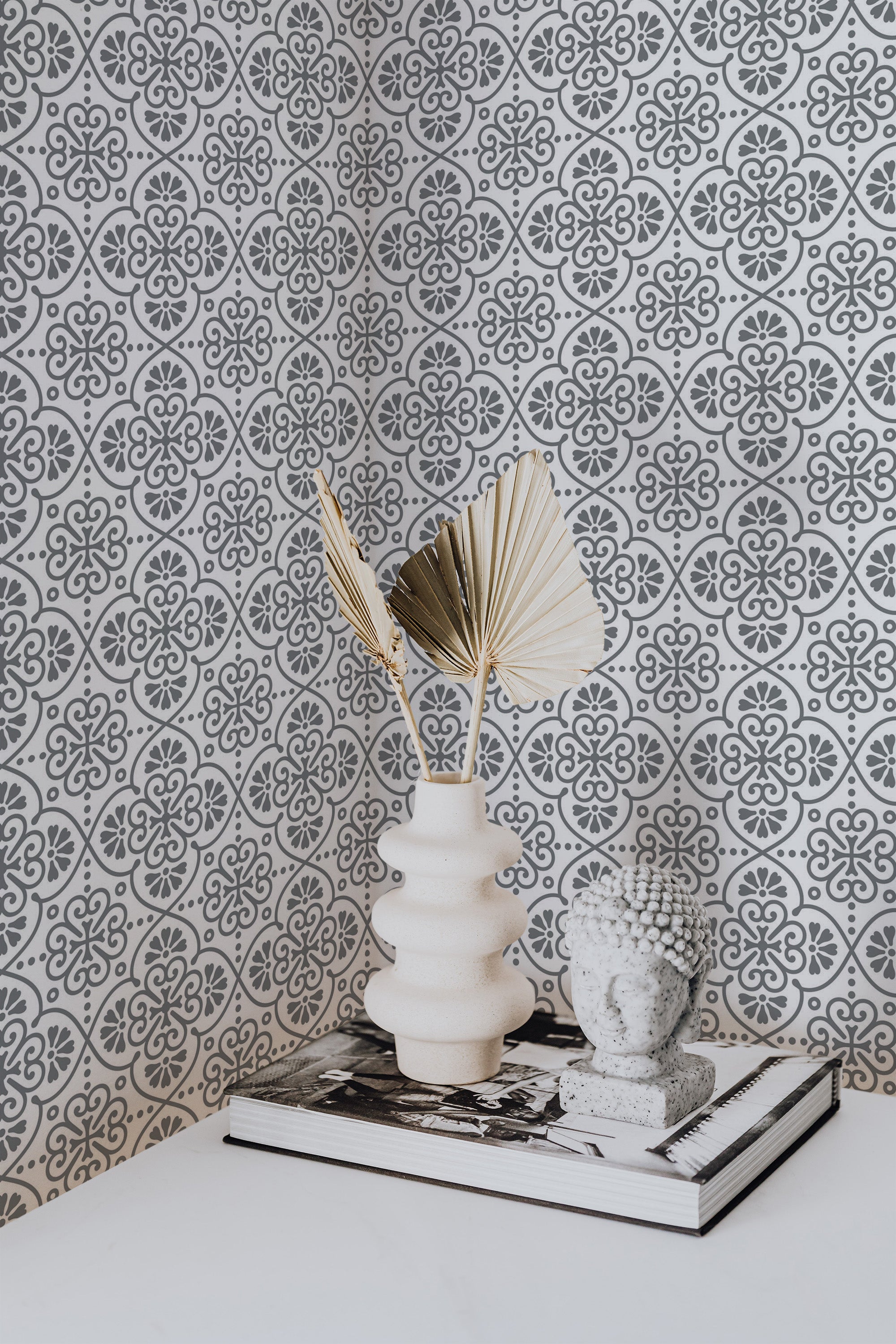 Self-adhesive wallpaper with an intricate Morocco design of repeating geometric patterns in black and white tones.