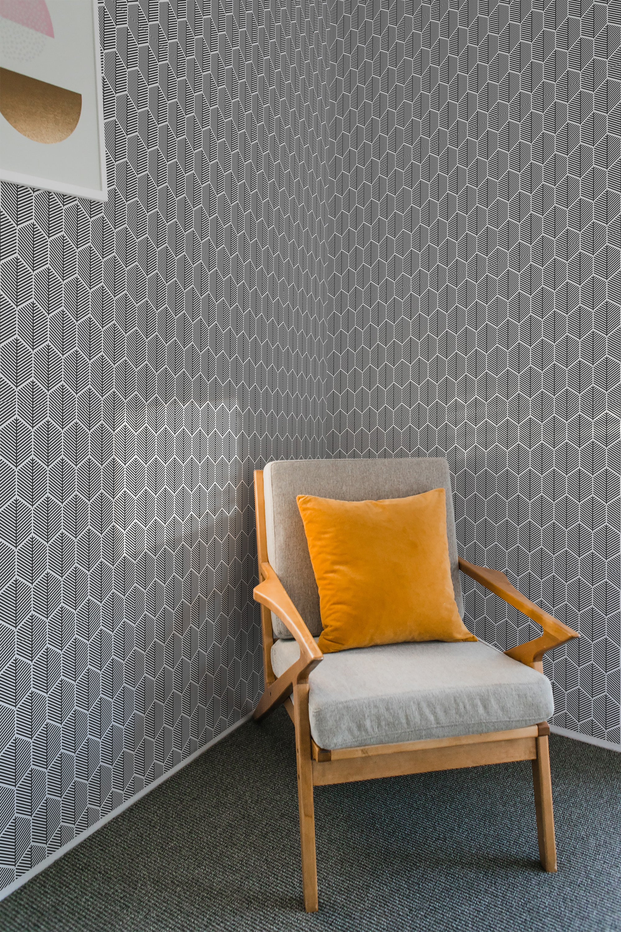 A room with walls covered in gray geometric honeycomb-patterned traditional wallpaper.