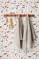 Self-adhesive Colorful Terrazzo wallpaper with a vibrant design of scattered multicolored shapes in pastel and bold tones, creating a playful and modern ambiance in the room.