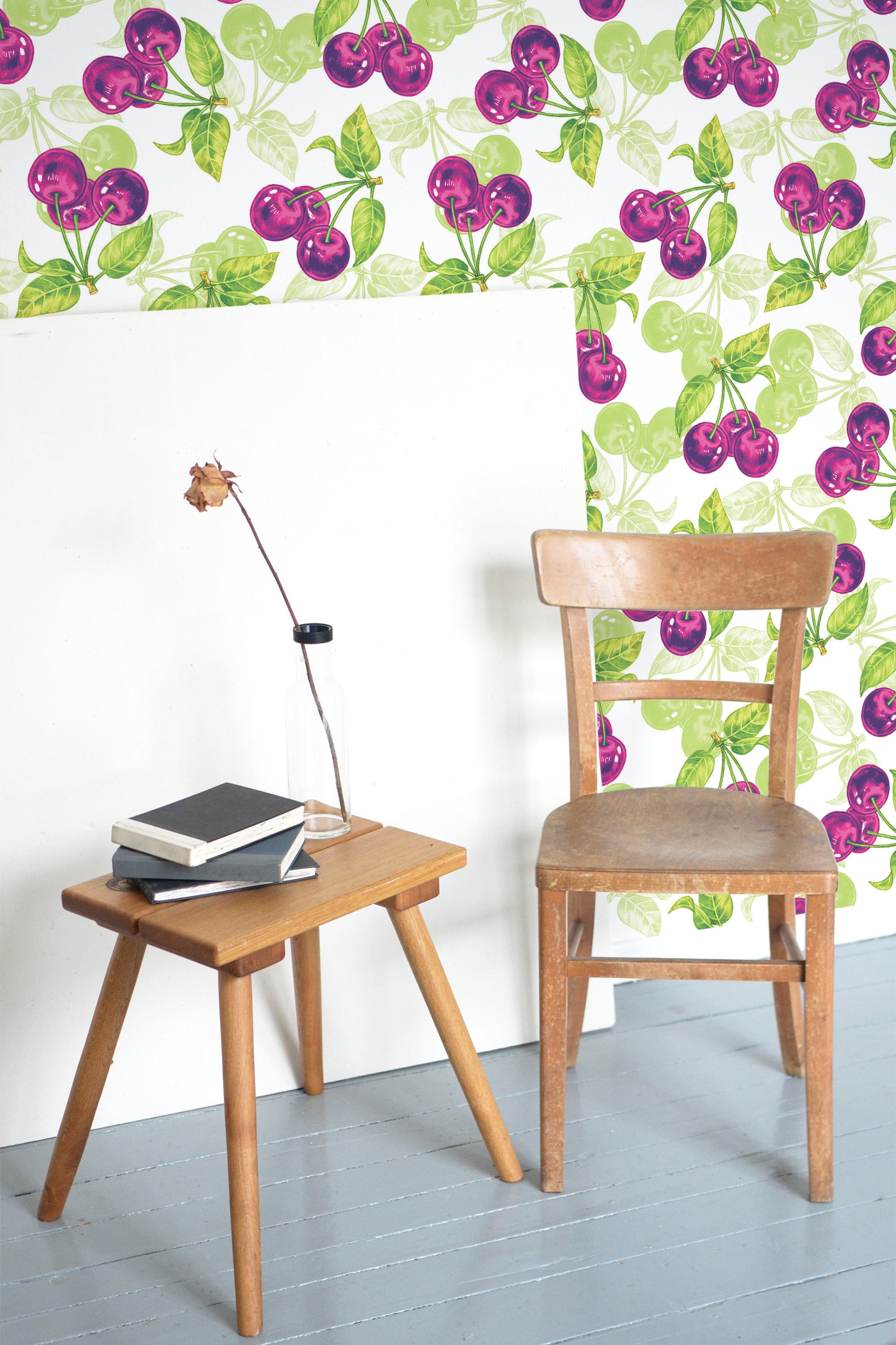 Self-adhesive wallpaper with a vibrant cherry pattern in shades of pink and purple, accented by green leaves against a light background.