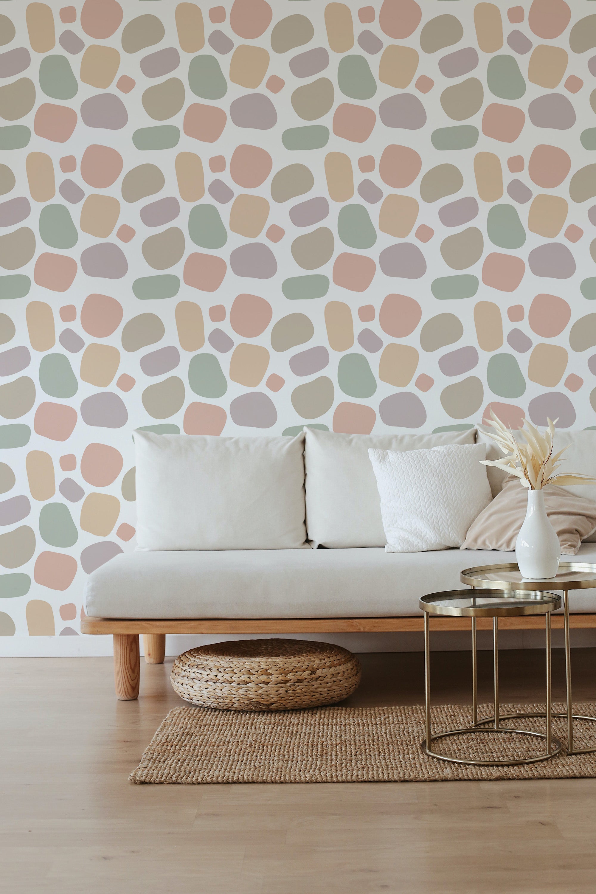 Abstract dots pattern wallpaper with irregular, scattered shapes in soft pastel shades of pink, beige, green, and gray on a white background. Complemented by minimalist furniture, this traditional wallpaper adds a modern, yet classic touch to the room���s ambiance.