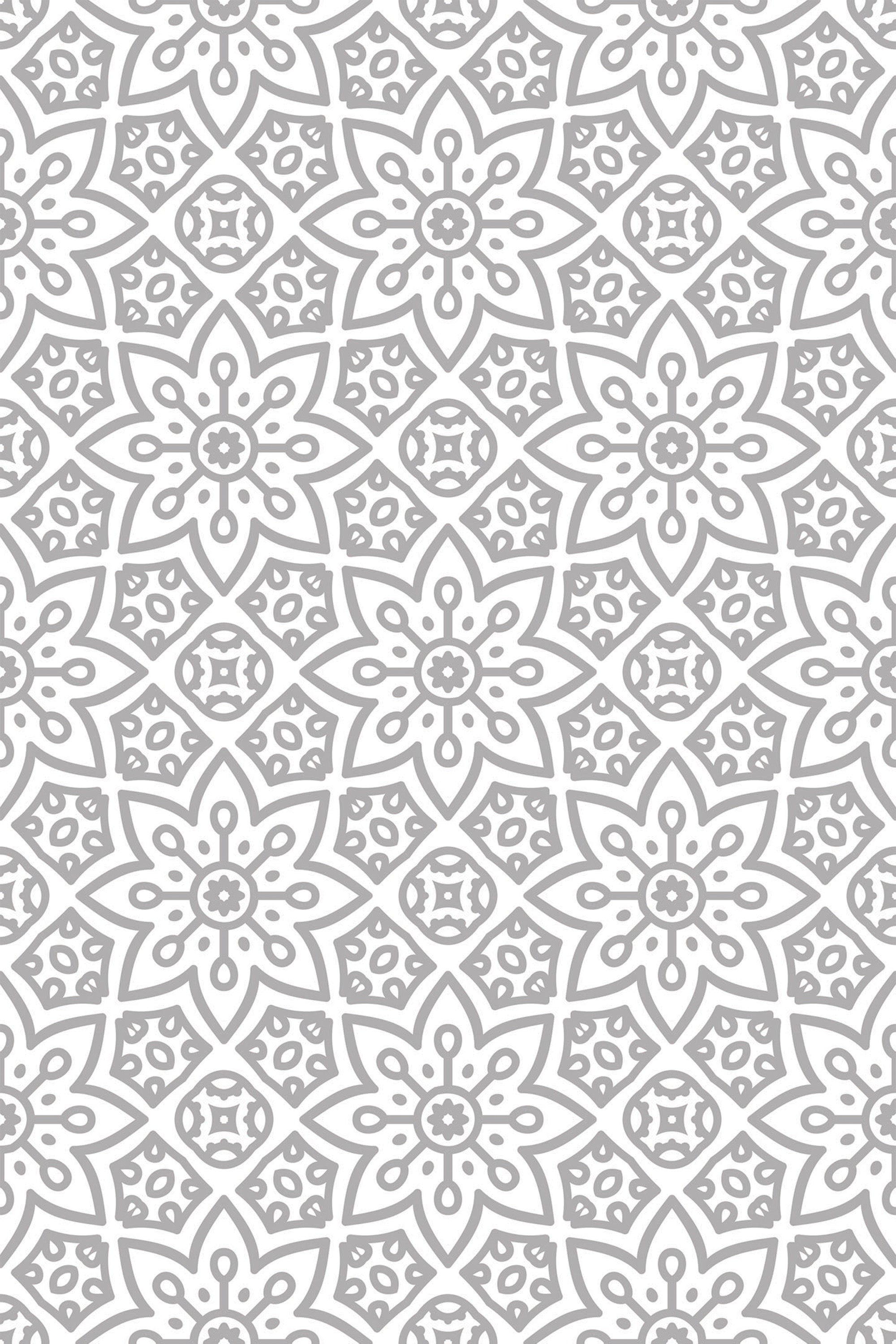Intricate floral and geometric patterns in shades of grey repeat in a symmetrical, ethnic-inspired design, creating a sophisticated and balanced appearance. Peel and stick removable wallpaper.
