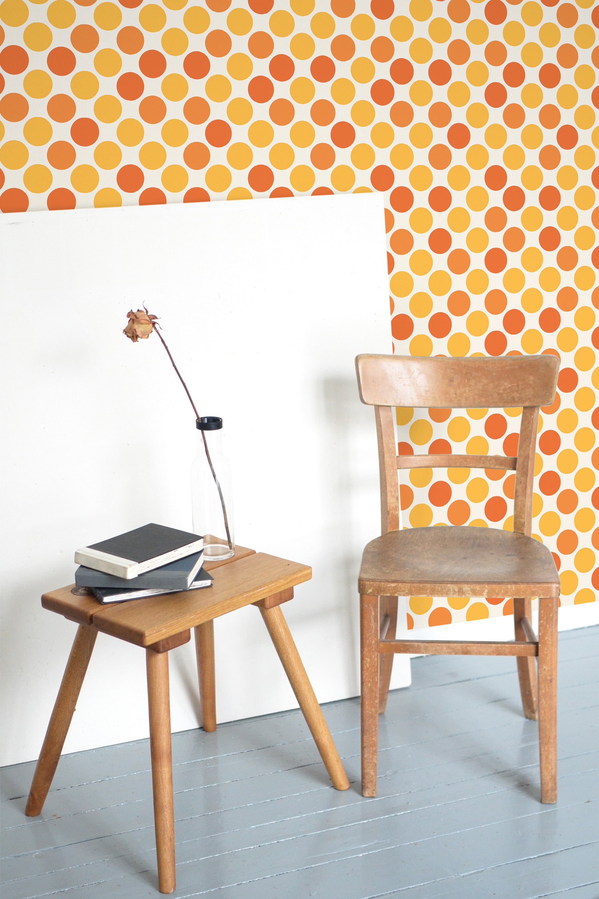 Self-adhesive wallpaper with a playful pattern of yellow and orange dots in a repeating geometric arrangement, adding warmth and a retro vibe to the room.