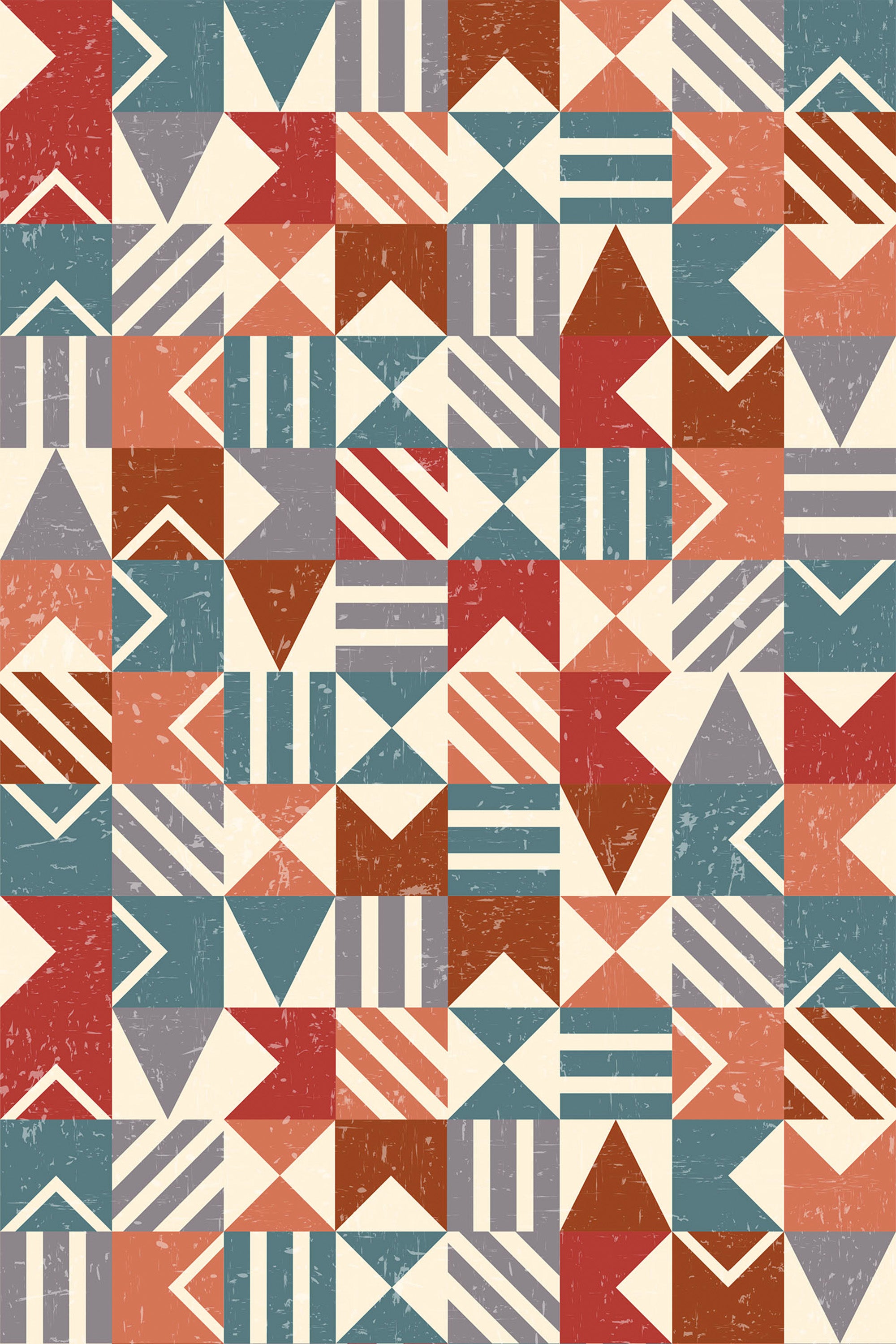 A retro-style geometric wallpaper with a mix of triangles, chevrons, rectangles, and stripes in earthy tones of red, teal, orange, and beige. The pattern has a slightly distressed texture, giving it a vintage feel. Peel and stick removable wallpaper.