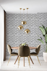 A modern dining room with wallpaper adorned with a pattern of small, evenly spaced black circles on a white background, providing a textured visual appeal. The wallpaper creates a subtle yet striking contrast with the gold accents in the room, adding a sophisticated touch to the space. Traditional wallpaper.